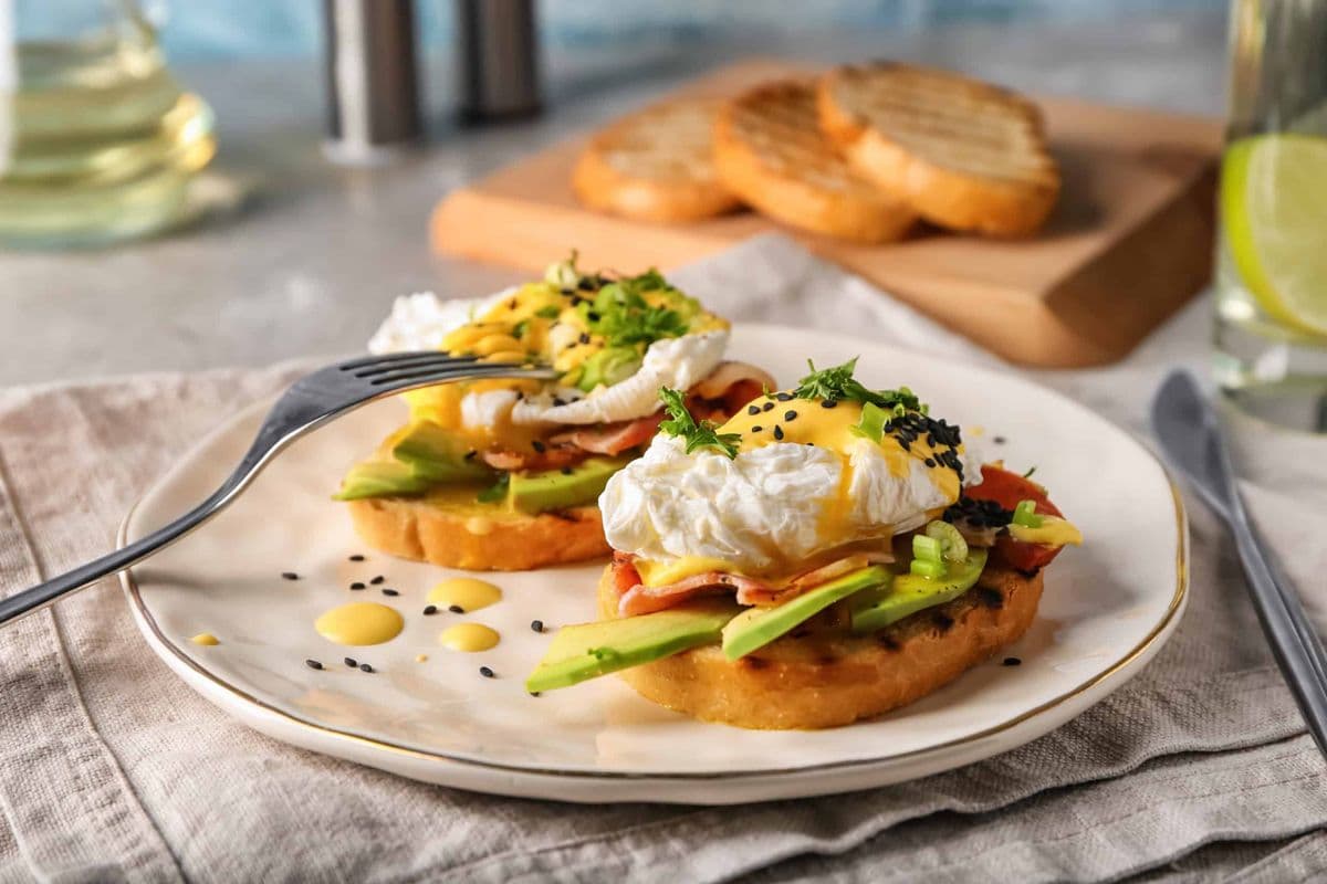Tasty eggs Benedict on plate