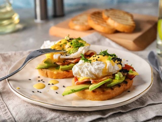Tasty eggs Benedict on plate