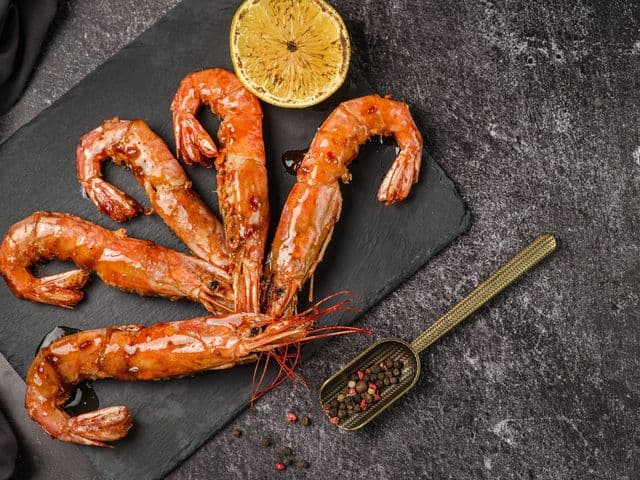 langoustines with lemon on a blackboard
